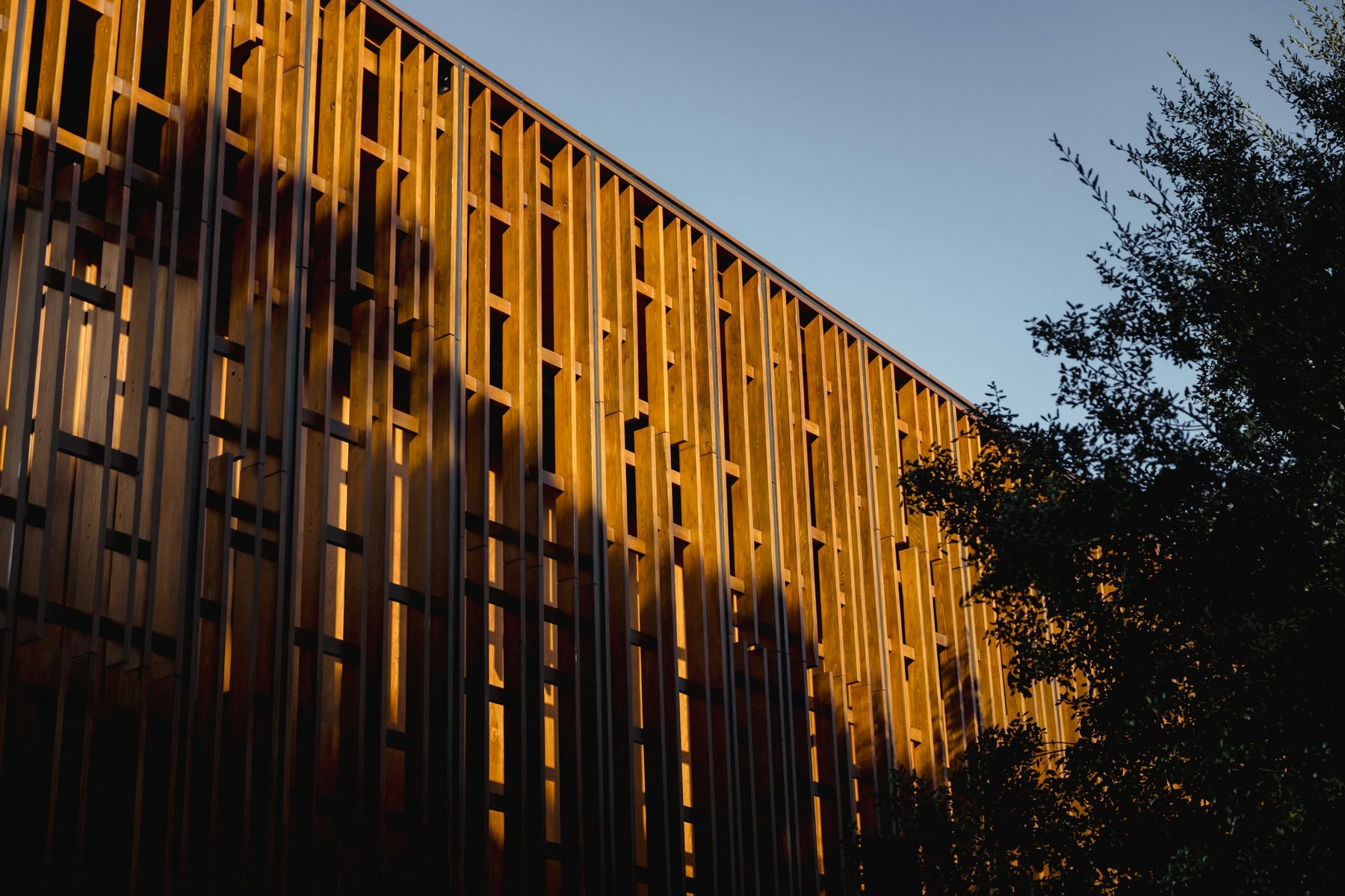 Sunlit architectural facade with a precise repeating rhythm; illustrative architecture